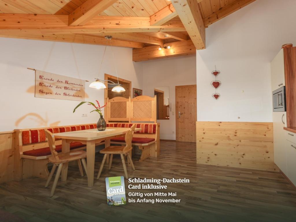 a kitchen and dining room with a table and chairs at Gästehaus Sieder by Schladming-Appartements in Schladming