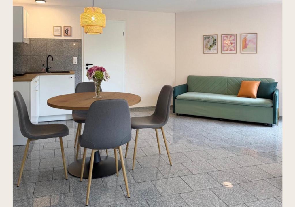 a living room with a table and a couch at hortensiengarten in Teningen