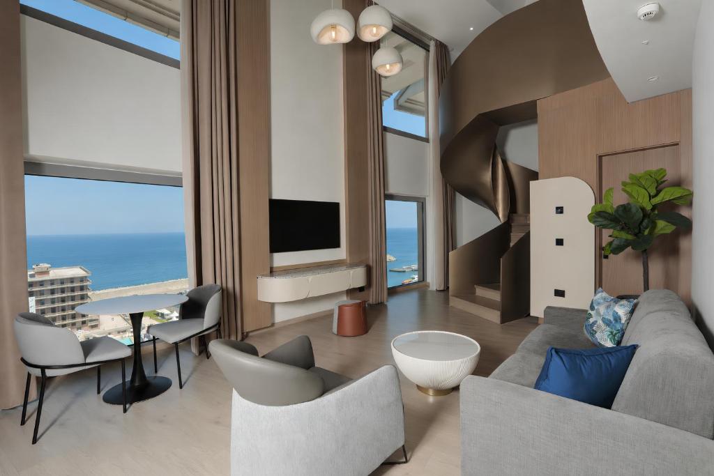 a living room with a couch and chairs at voco Beirut Central District by IHG in Beirut