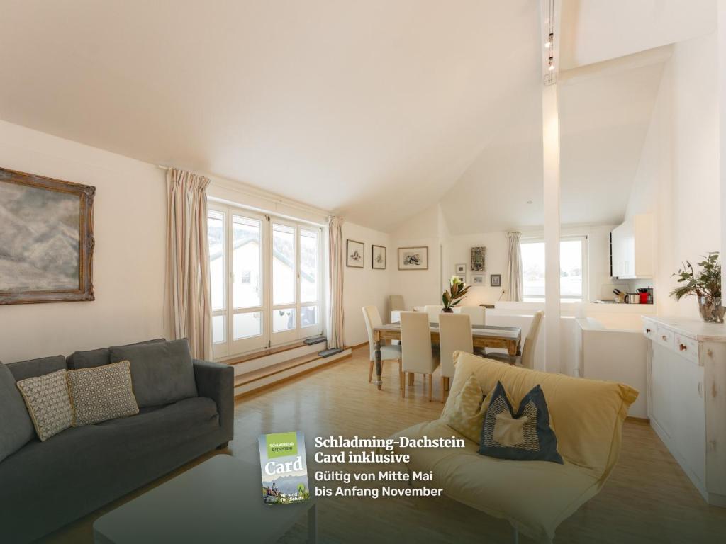 a living room with a couch and a dining room at Appartmenthaus Centro by Schladming-Appartements in Schladming