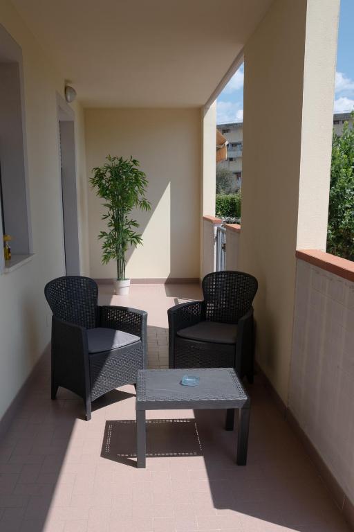 a balcony with chairs and a table and a plant at Il Sogno di Ilaria in Arezzo
