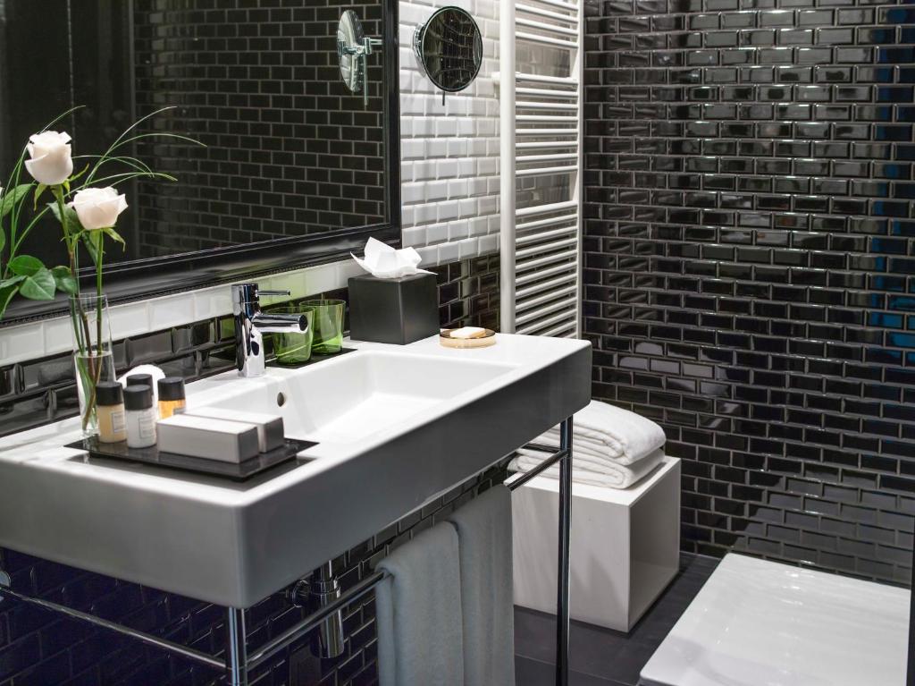 a bathroom with a white sink and a mirror at The Principal Madrid, Small Luxury Hotels in Madrid