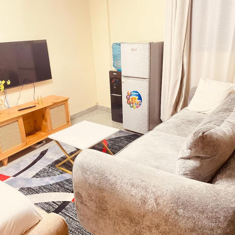 a living room with a couch and a refrigerator at Studio apartment in Ruka in Ruaka