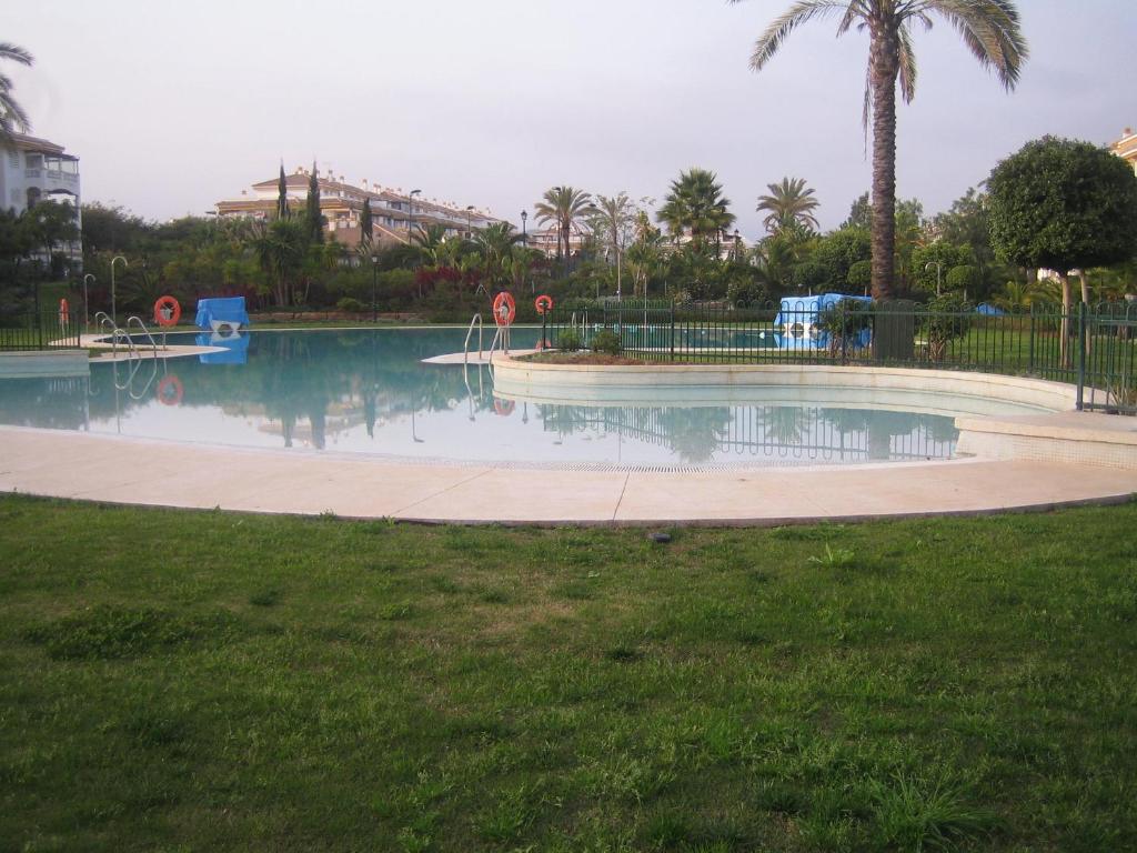 a swimming pool with a playground in a park at Atico Marbella Puerto Banus in Marbella