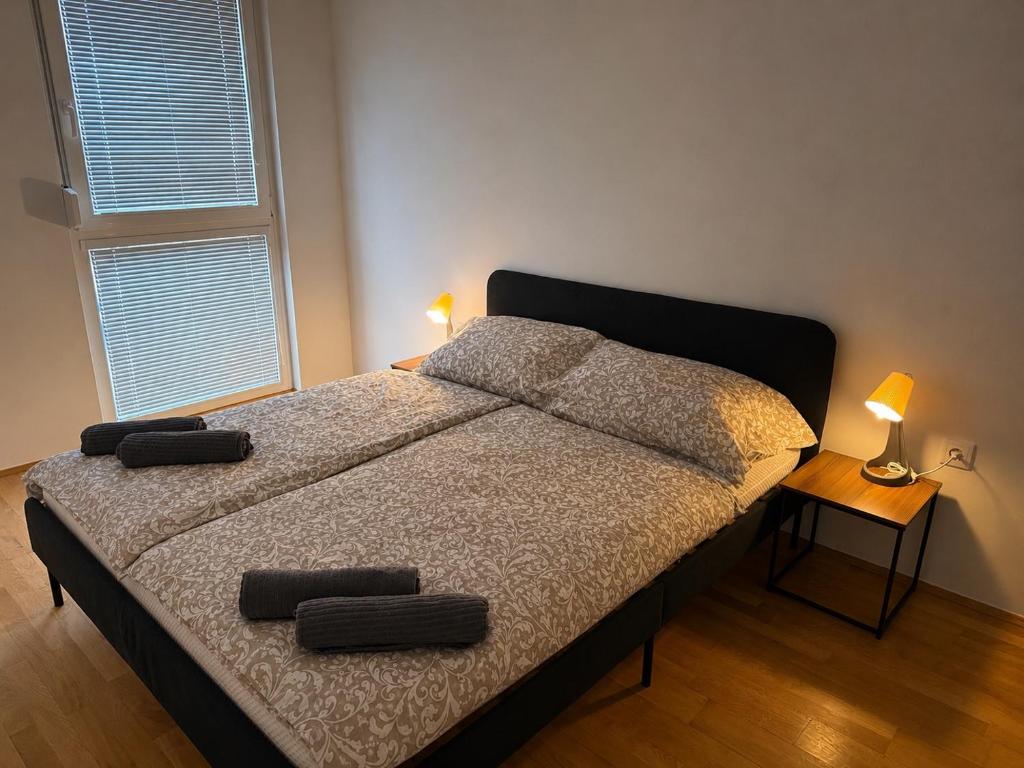 a bedroom with a bed with two pillows on it at QuietApt Vienna in Vienna