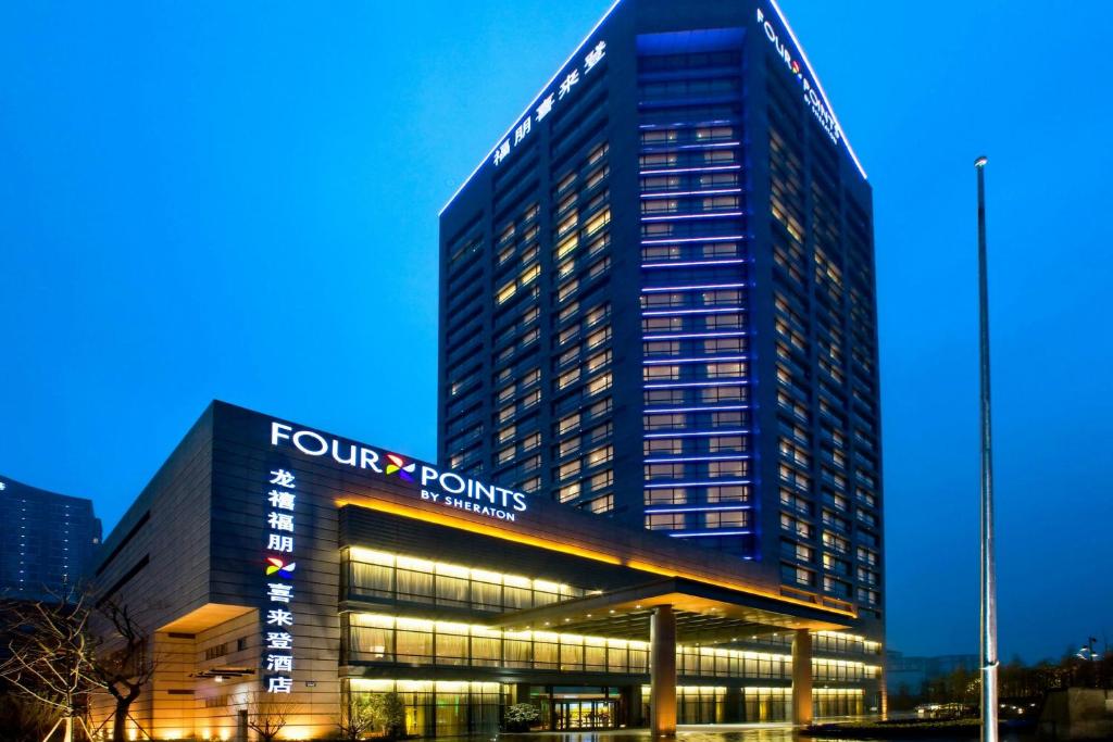 a tall building with a four points sign on it at Four Points by Sheraton Hangzhou, Binjiang in Hangzhou