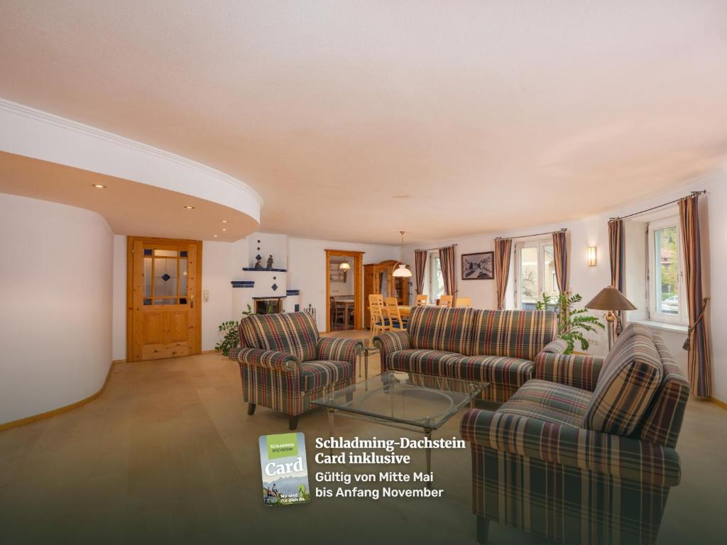 a living room with two couches and a table at Appartement Dachsteingasse by Schladming-Appartements in Schladming