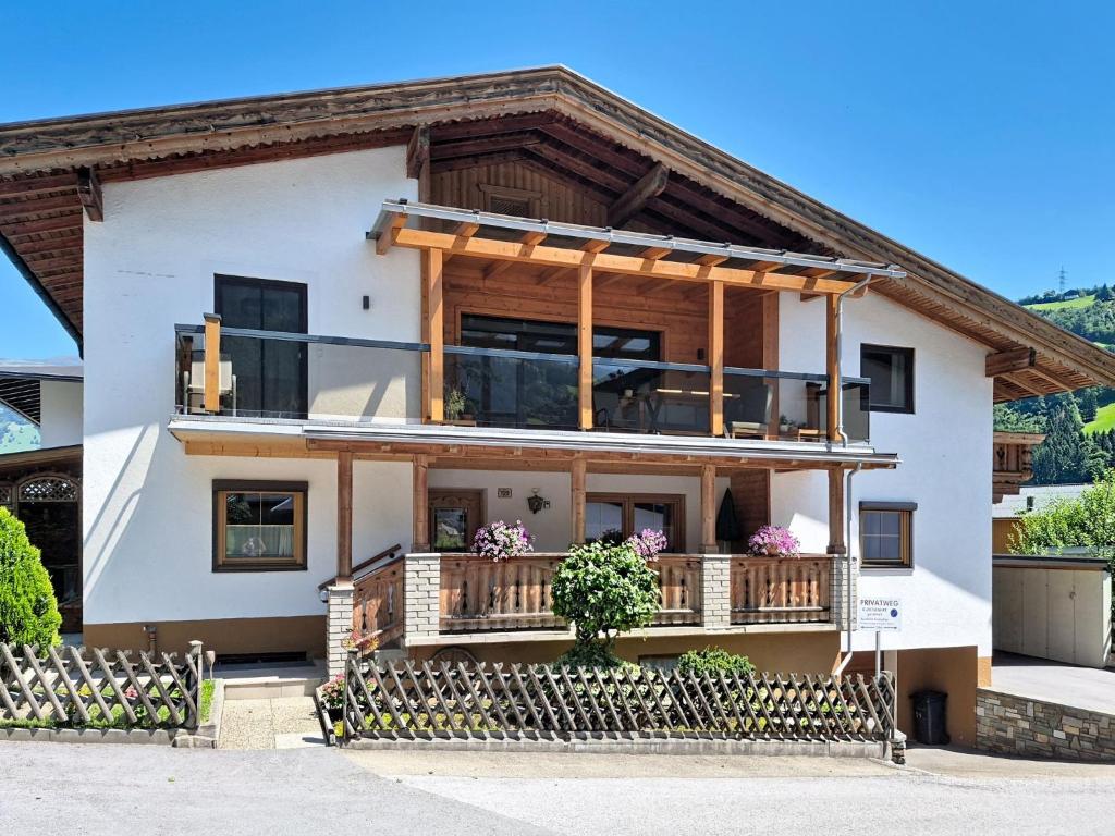 a house with a balcony with flowers on it at Apartment Manuel by Interhome in Hippach