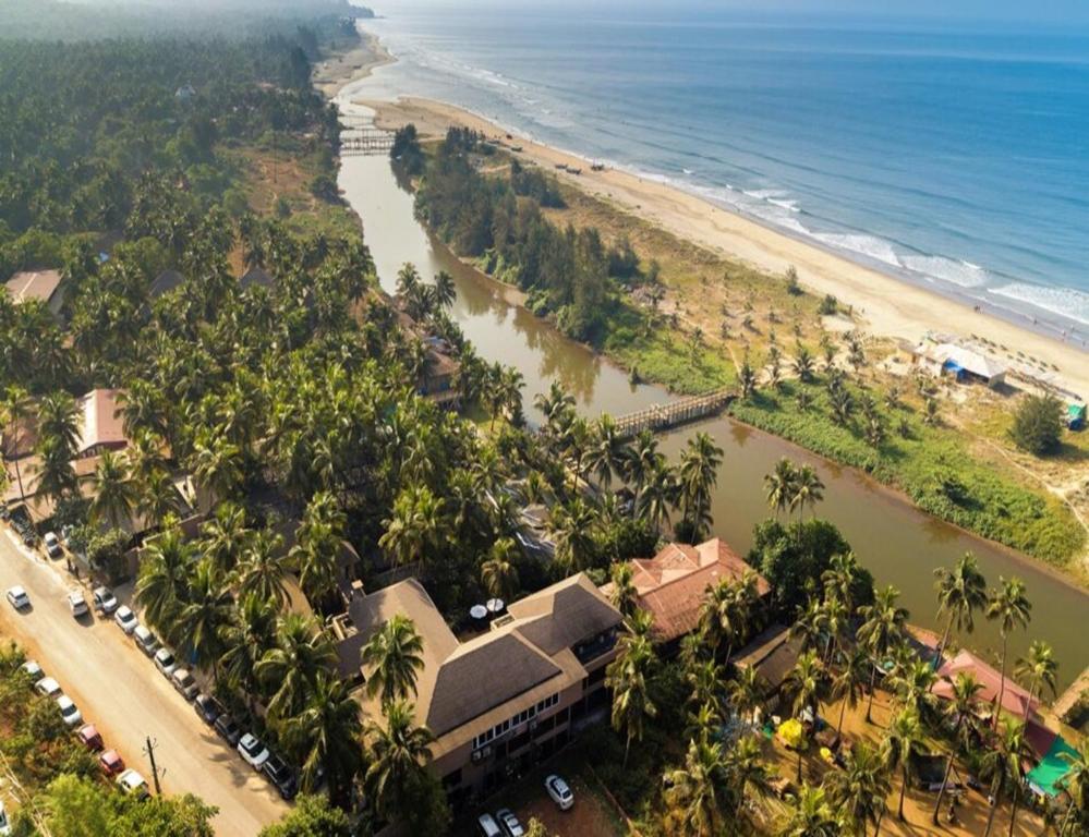 an aerial view of a beach with a river at Riva Beach Resort in Mandrem