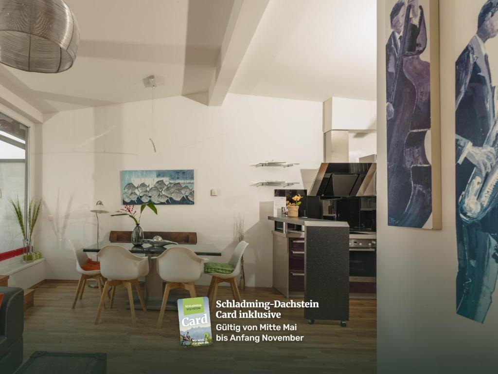 a kitchen and dining room with a table and chairs at Appartements Tamino by Schladming-Appartements in Schladming