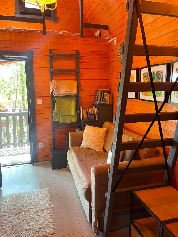 a bedroom with a bunk bed and a ladder at Makkocska Vendégház in Noszvaj