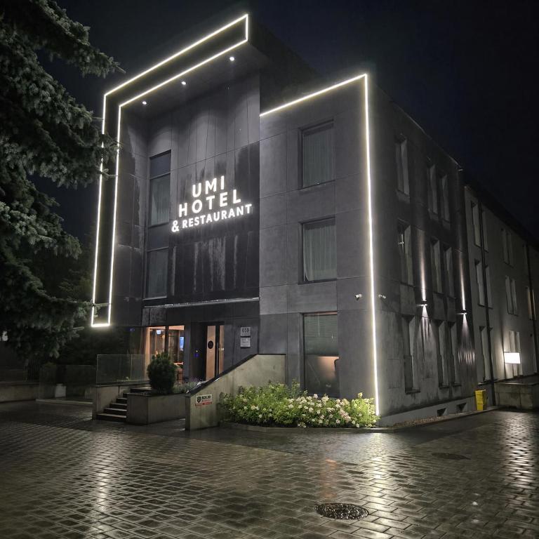 a building with a sign on the side of it at night at Great Polonia Umi Hotel Sopot in Sopot