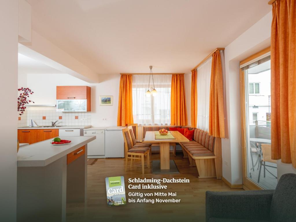 a kitchen and living room with a table and a couch at Appartementhaus Steirergasse by Schladming-Appartements in Schladming