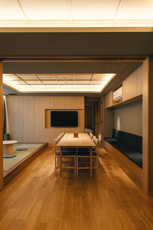 a conference room with a table and a tv at Apartment Hotel UCHIWA STAY Osaka NAMBA in Osaka