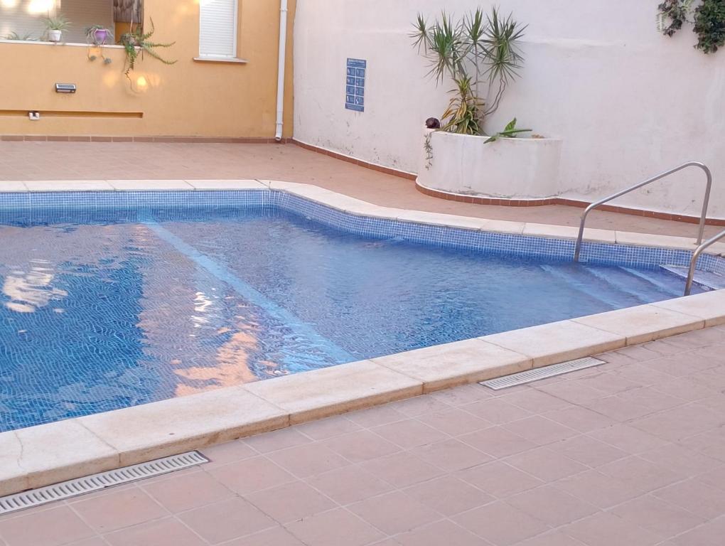 a swimming pool with a tile floor at Pescadors in Les Cases d'Alcanar