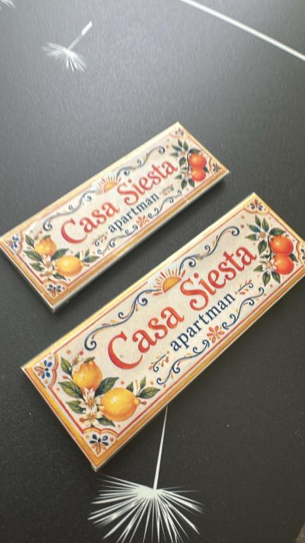 two boxes of coca cola signs on a table at Casa Siesta apartman in Makó