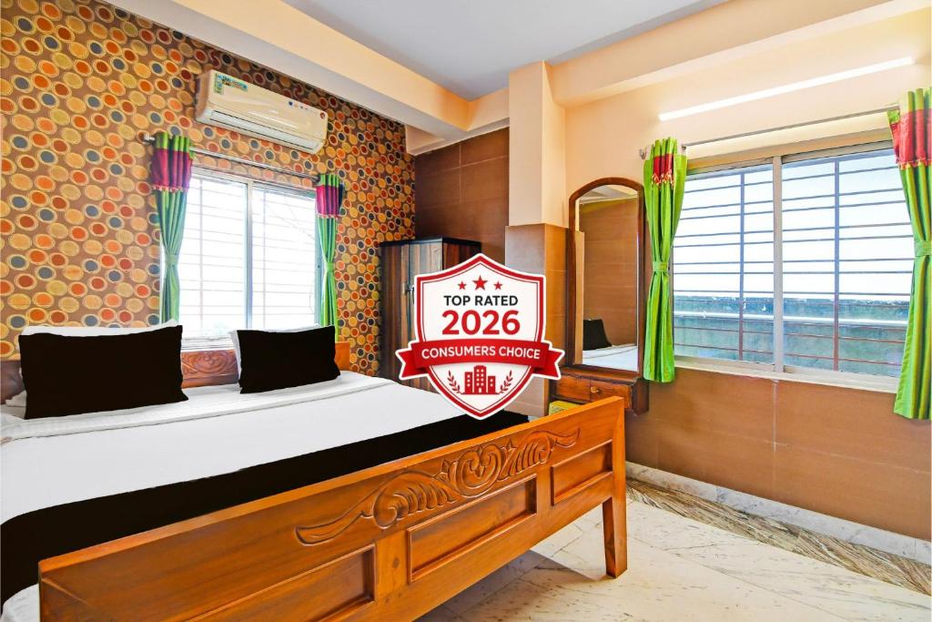 a bedroom with a bed with a sign that says at Super Hotel O Rishra Railway Station Formerly Green Guest House in Khardah