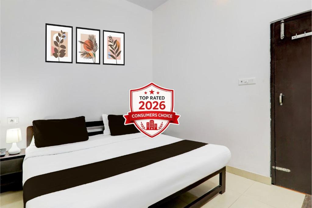 a bedroom with a bed with a sign on it at Super OYO Hotel O Indira Nagar in Lucknow