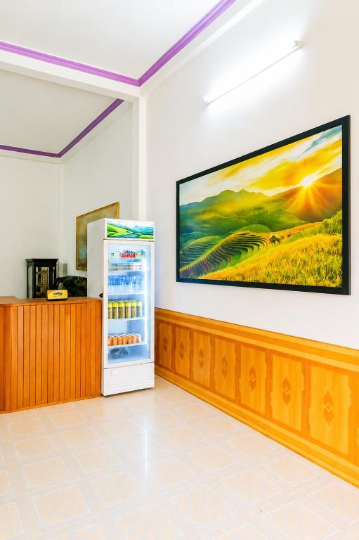 a refrigerator in a room with a painting on the wall at Linh Chi Hotel in Mù Cang Chải