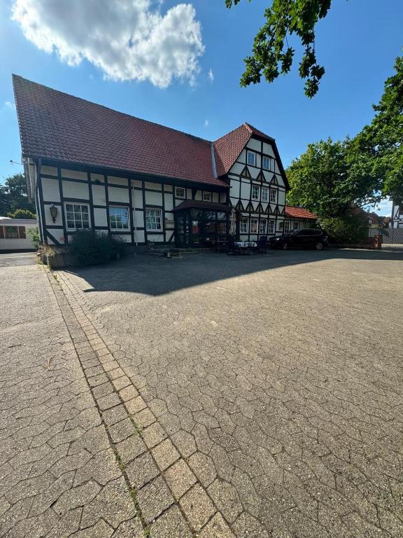a large white and black building with a roof at Heritage Timber Stay in Wendeburg
