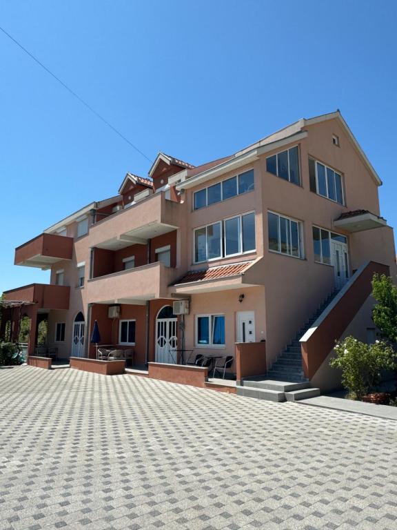 a large apartment building with a driveway in front of it at Apartmani Slađo in Trebinje