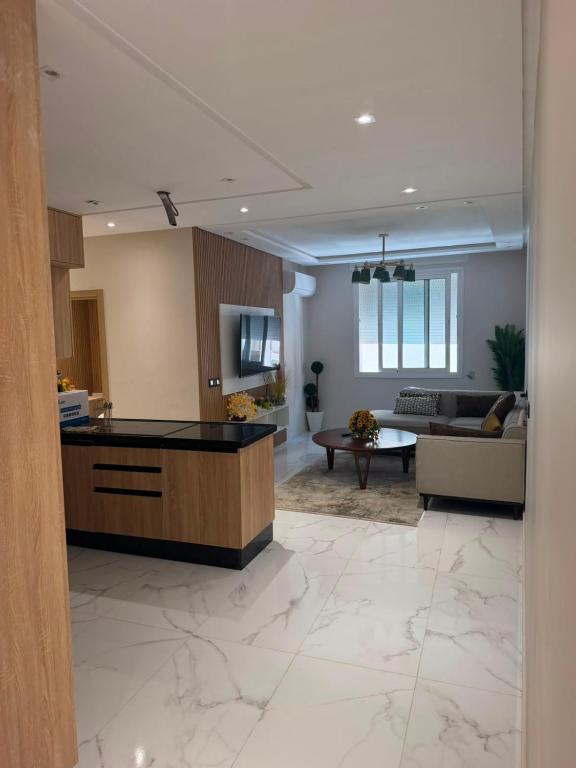 a kitchen and living room with a couch and a table at appartement de luxe tanger in Tangier