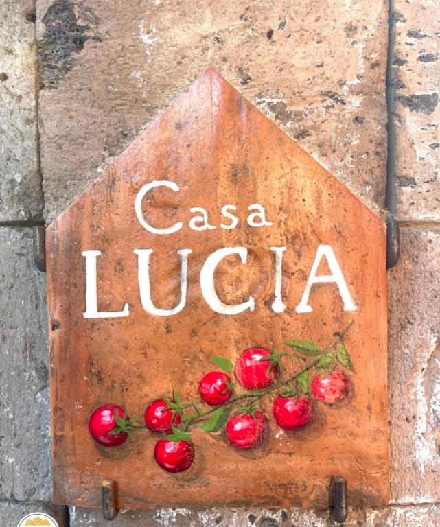 a sign that says casa luita sitting on the ground at Casa Lucia in Sorrento