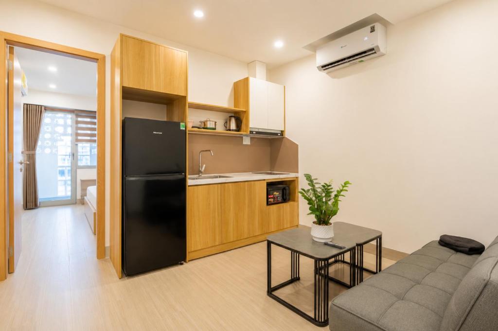 a kitchen and living room with a black refrigerator at Minh Khang Apartment in Danang