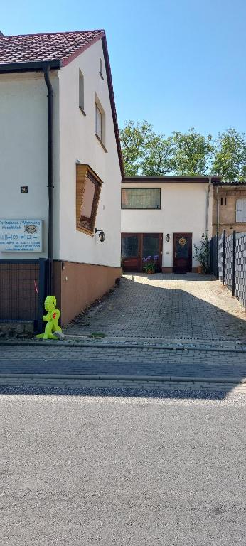 a yellow stuffed animal sitting on the side of a building at Ferienhaus - Wohnung- Havelblick in Phöben