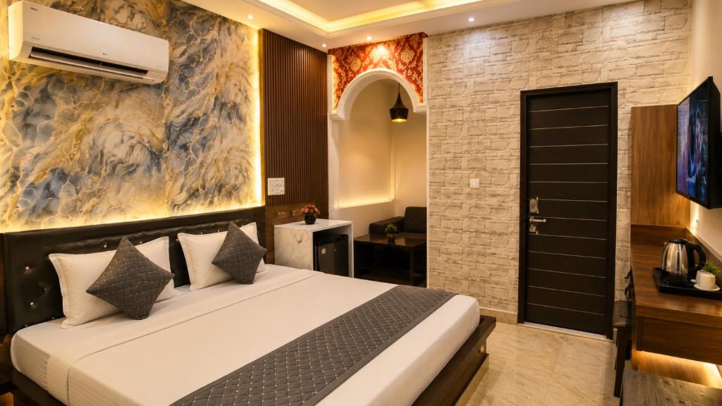 a bedroom with a bed in a room at Hotel The Montana Suite - Free Airport and Aerocity Pickup & Drop in New Delhi