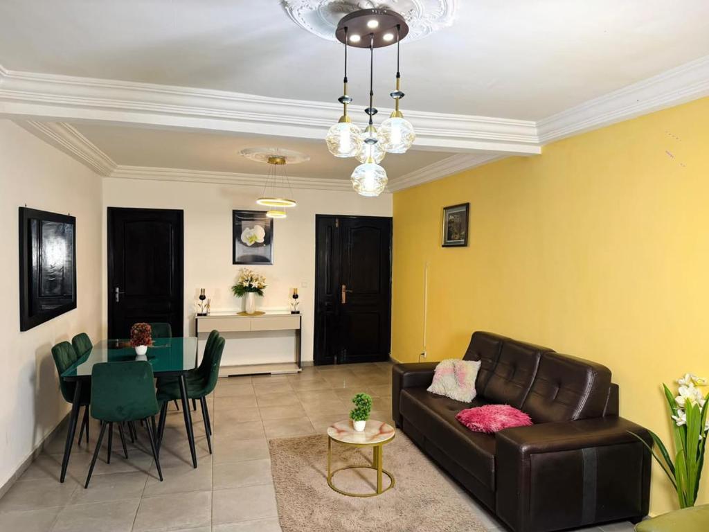 a living room with a couch and a table at Immeuble paco in Douala