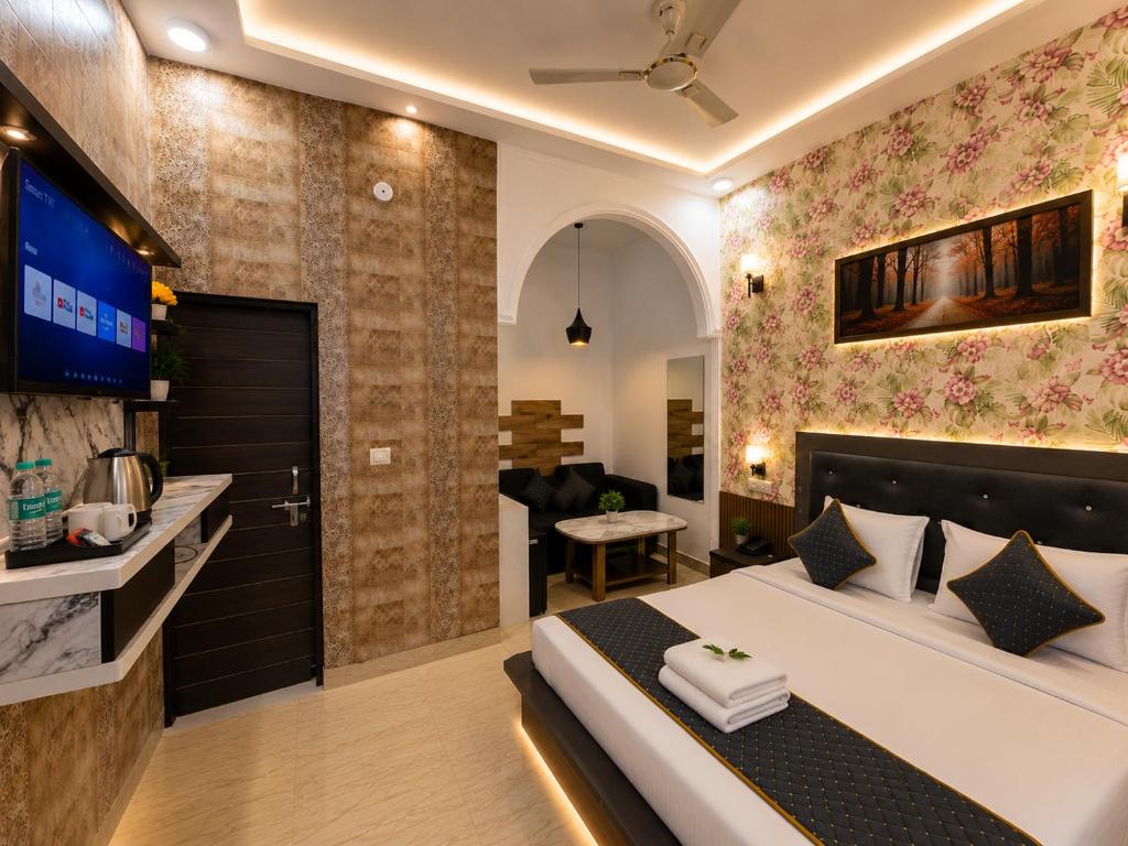 a bedroom with a bed and a living room at Hotel Bell Montana Stay Near IGI Airport Delhi- Free Airport Pickup & Drop in New Delhi