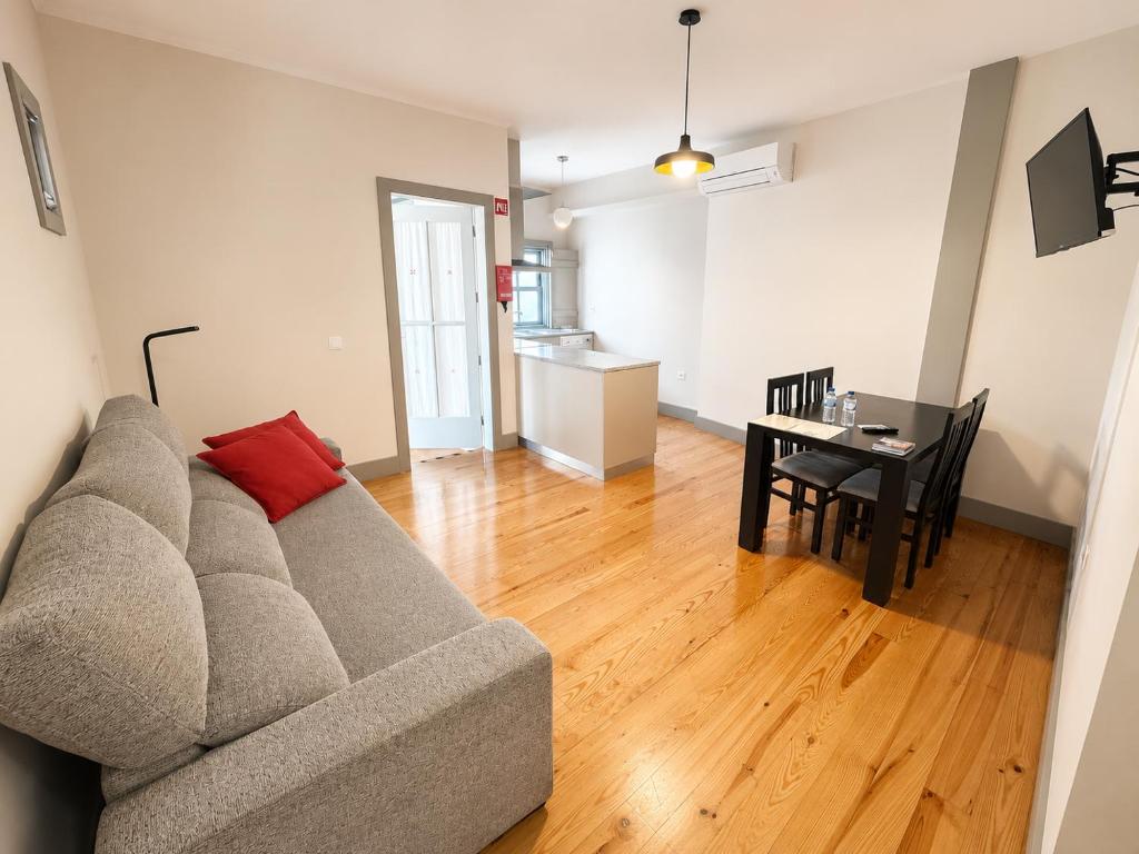 a living room with a couch and a table at Guest House Vimaranes in Guimarães