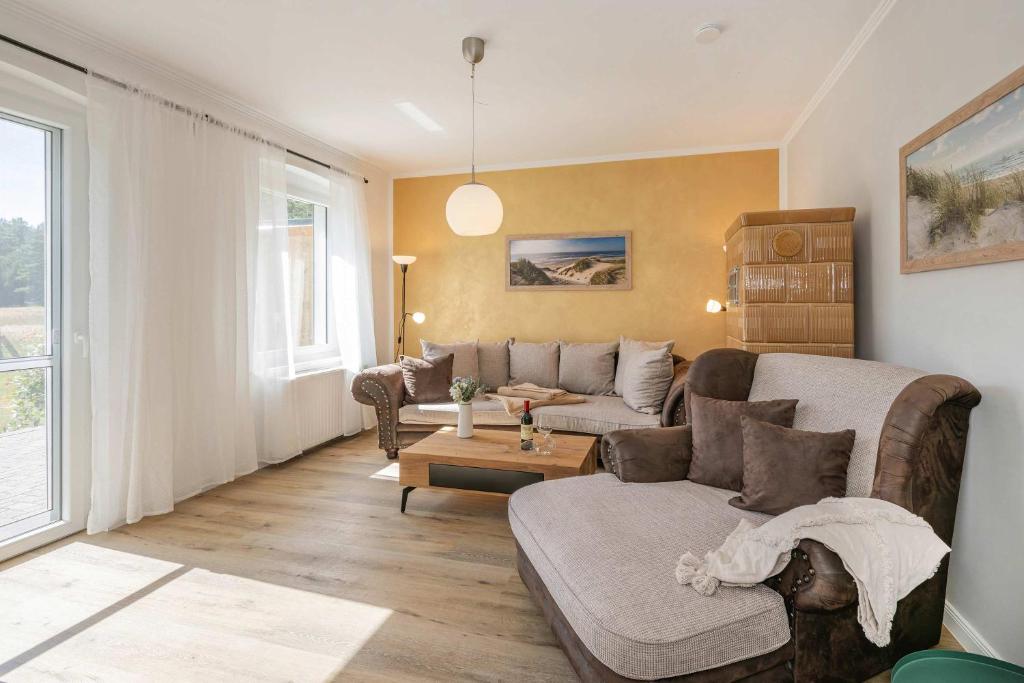 a living room with a couch and a table at Ferienhaus Oscar in Garz