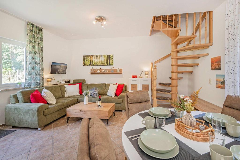 a living room with a couch and a staircase at Ferienwohnung Emily in Garz