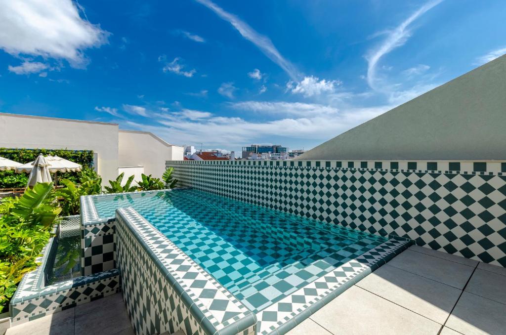 a swimming pool on top of a building at TURIM Lisboa Hotel in Lisbon