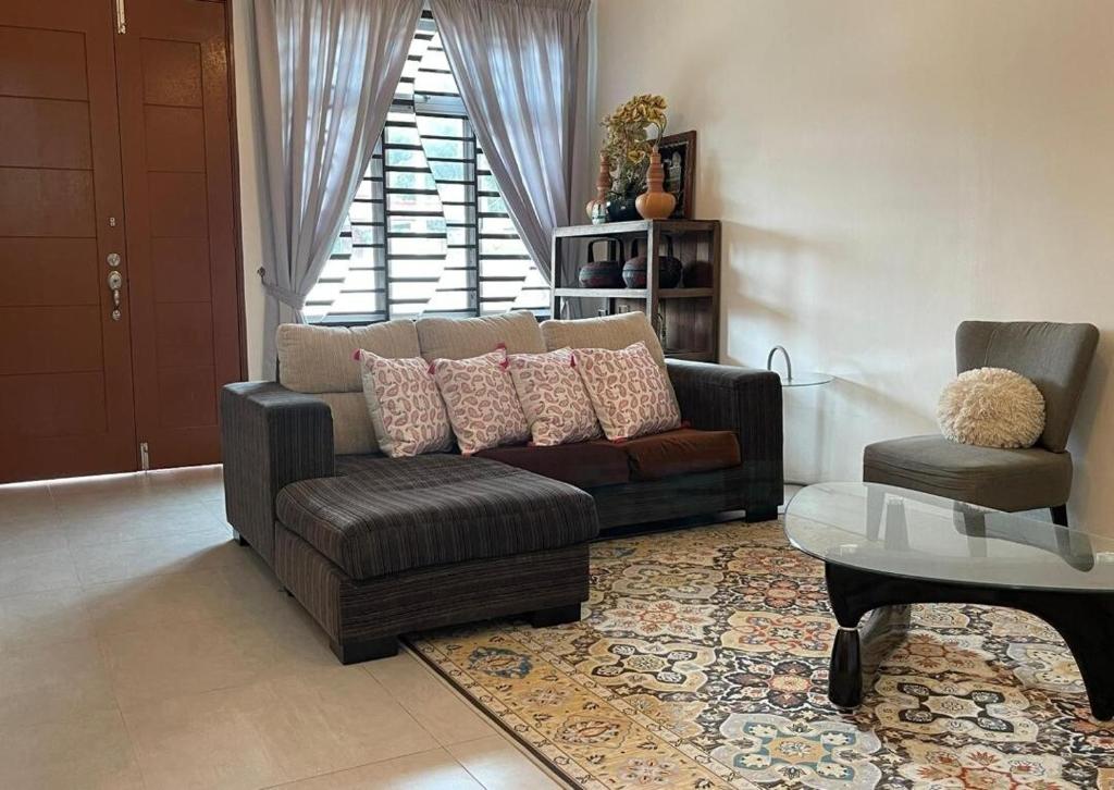a living room with a couch and a chair at RUANG by ZD in Pekan
