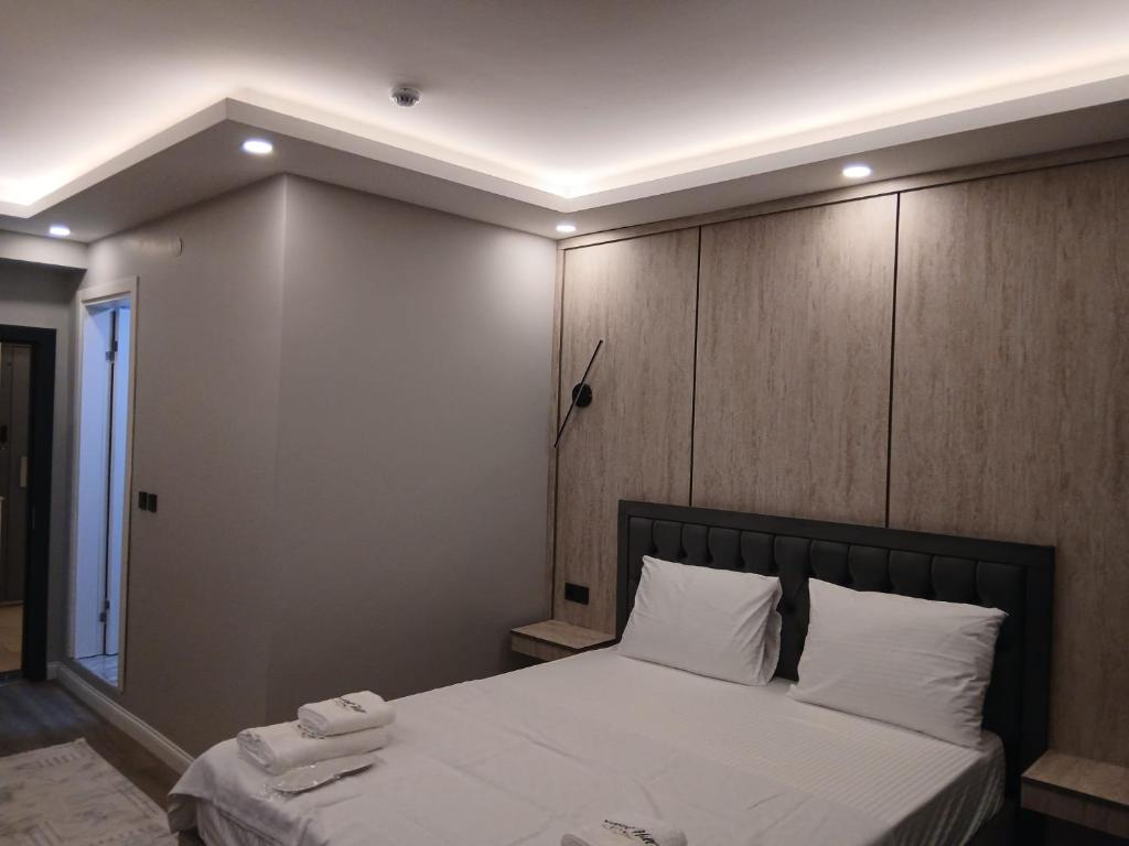 a bedroom with a bed with a large wooden headboard at Sunset hill in Büyükçekmece