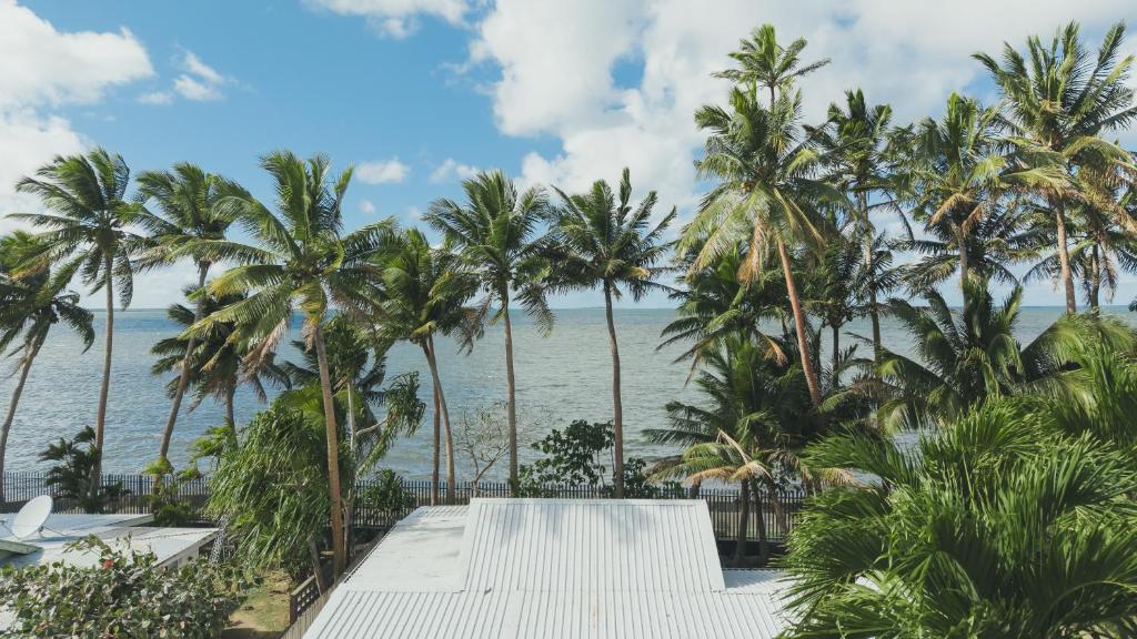 a view of the ocean from a resort with palm trees at Suva Point Ocean Front Nukulau Island Views in Suva