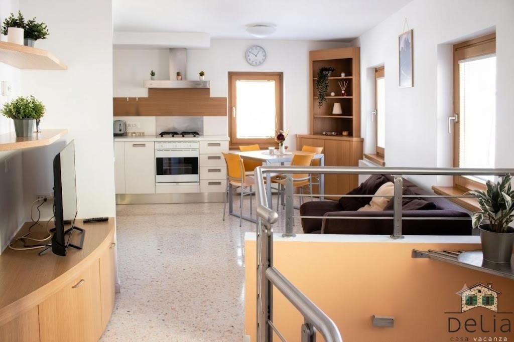 a kitchen and living room with a couch and a table at Casa Delia in Longarone