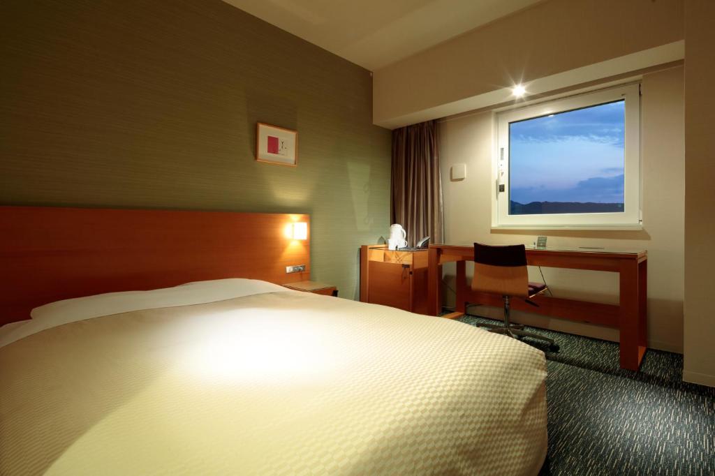 Postel nebo postele na pokoji v ubytování Candeo Hotels Fukuyama