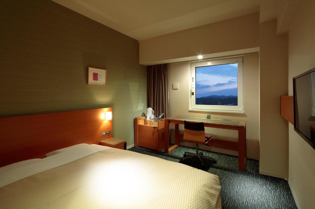 Postel nebo postele na pokoji v ubytování Candeo Hotels Fukuyama