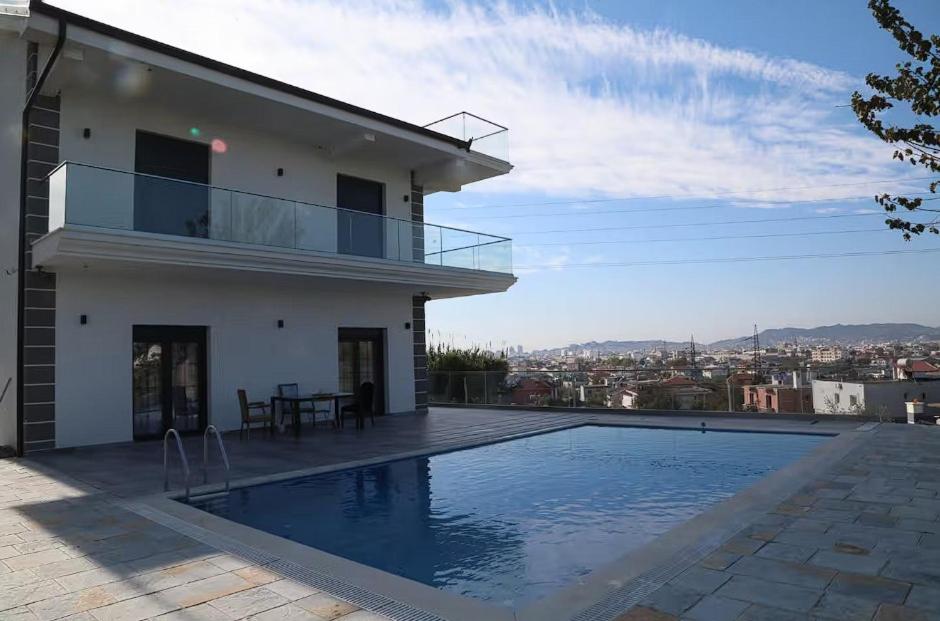 a house with a swimming pool on a roof at Located in a quiet area ! in Durrës