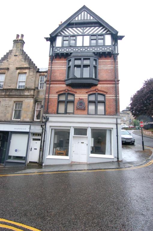 a tall brick building on a city street at Baker Street Retreat in Stirling