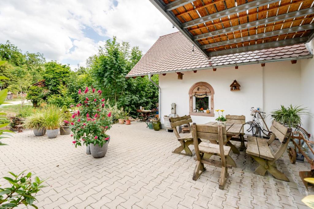 a patio with a table and chairs and plants at Haus Redi in Sasbach in der Ortenau