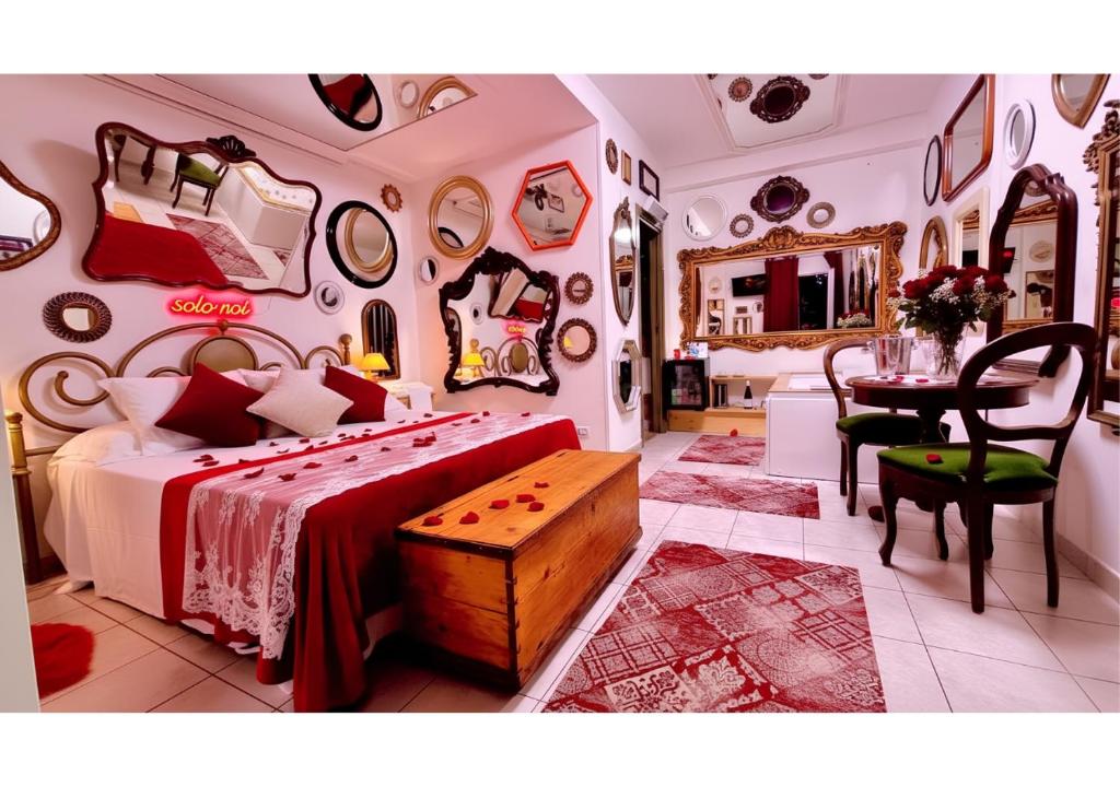 a bedroom with a bed and a table and mirrors at Pupi Catania Etna Farm in Catania