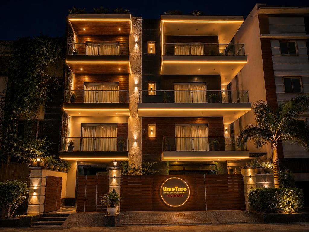 a building with a sign in front of it at night at Lime Tree Hotel Pulkit Gurgaon-Artemis Hospital, Nearest Metro Huda City Centre in Gurgaon