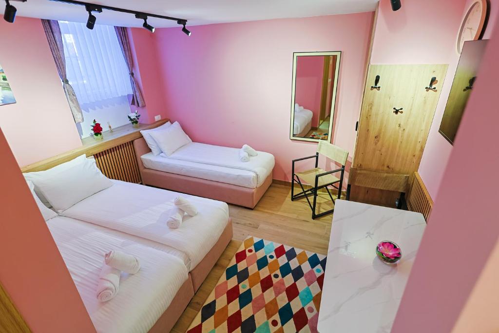 a small room with two beds and a mirror at FourMountains-Igman in Sarajevo