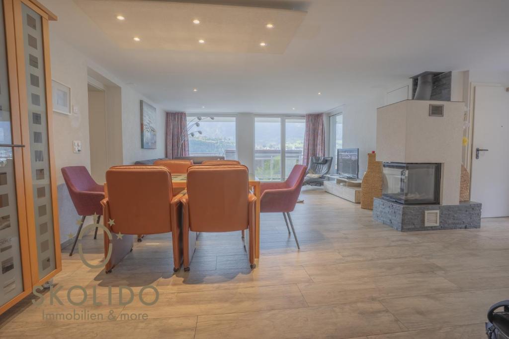 a dining room with a table and chairs at Casa Sunegga in Naters