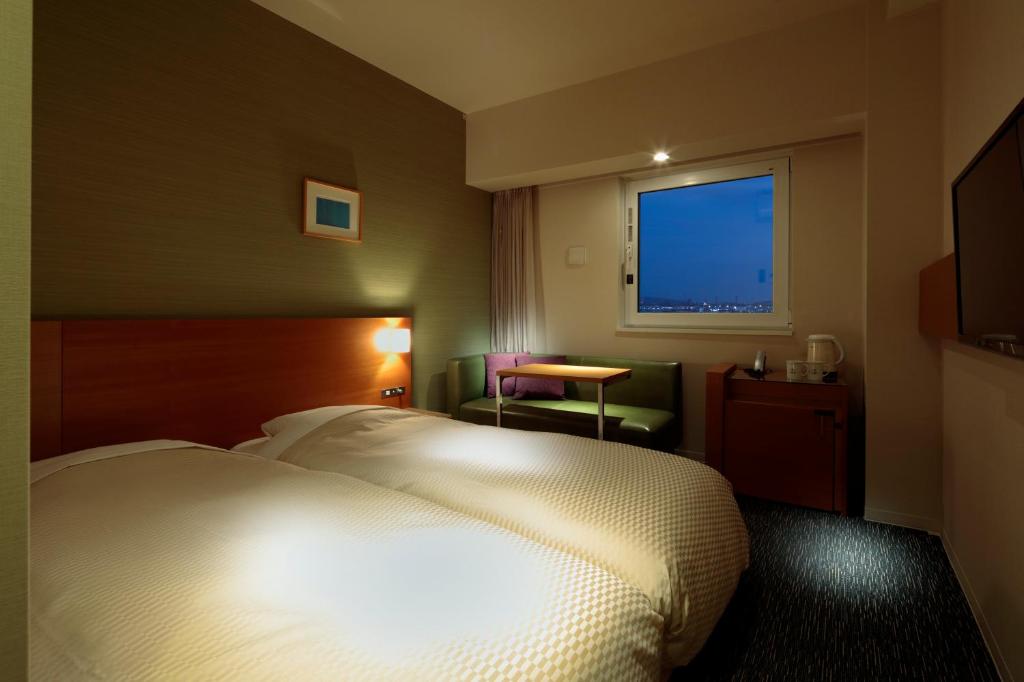 Postel nebo postele na pokoji v ubytování Candeo Hotels Fukuyama